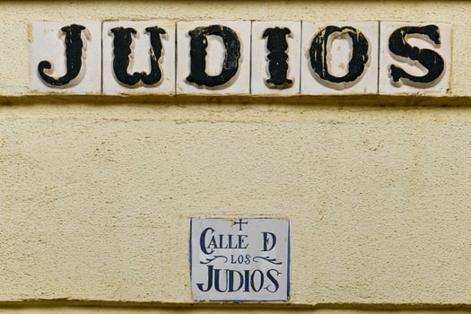 A street sign to the entrance of the Jewish quarter in Cordoba, Spain inscribed with Street of the Jews. photo