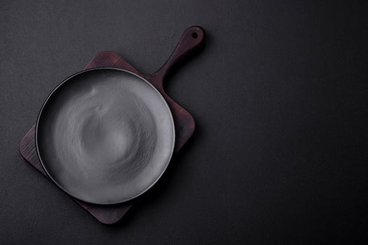 Empty ceramic round plate on dark textured concrete background photo