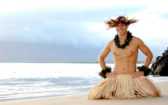 Male Hula Dancer ends a performance on the sand with a big smile. photo