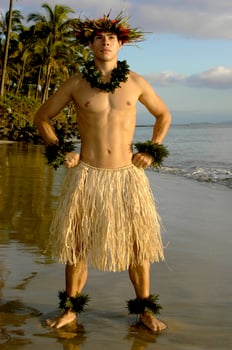 Hawaiian male hula dancer with a power pose at sunset by the beach. photo
