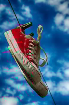 pair of red sneakers on clothesline photo