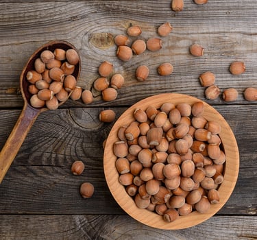 hazelnut nuts in a brown wooden bowl photo