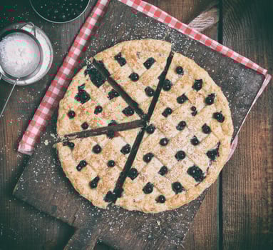 baked round black currant cake photo