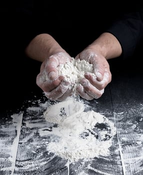 white wheat flour in male hands photo