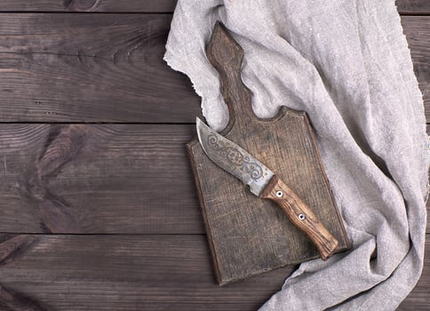 old wooden kitchen board and vintage knife photo