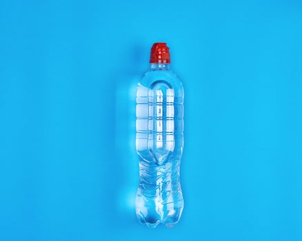 transparent plastic bottle with fresh water on a blue background photo