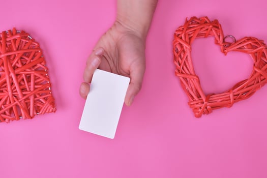 empty white rectangular business card in a female hand photo