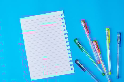empty paper sheet in a line and multi-colored gel pens photo