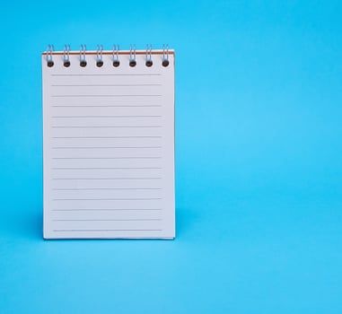 open blank notebook in line on a blue background photo
