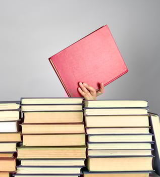 stack of different books on a gray background photo