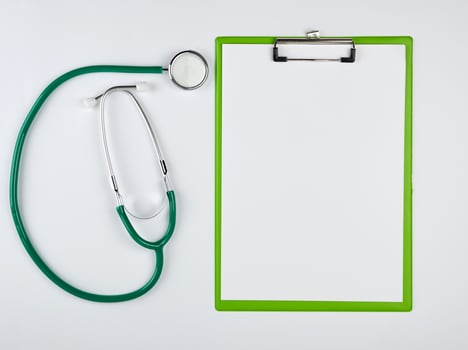 empty white sheets and medical stethoscope on a white background photo