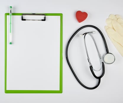 black medical stethoscope and green paper holder photo