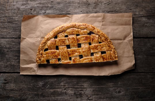 half cherry pie on brown paper photo