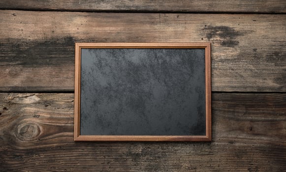 wooden empty chalk board on a brown wooden background photo