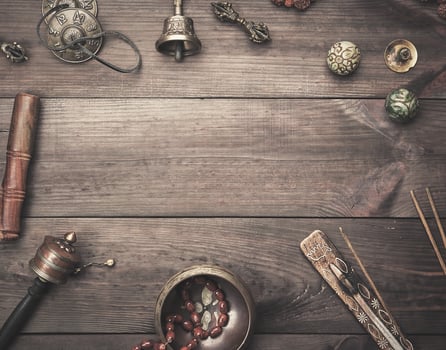 Copper singing bowl, prayer beads, prayer drum and other Tibetan religious objects for meditation and alternative medicine photo