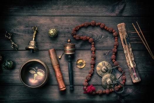 Copper singing bowl, prayer beads, prayer drum and other Tibetan religious objects for meditation photo