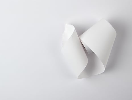 white piece of paper is twisted,  white background photo