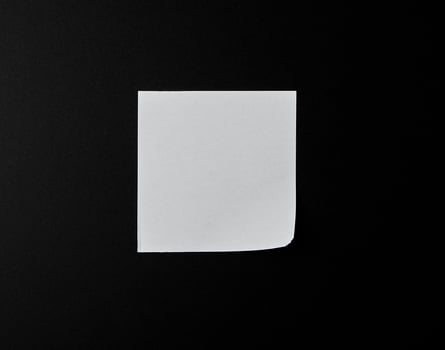 empty white sheet of paper on a black background photo