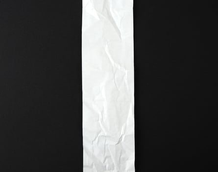 blank strip of paper on a black background photo