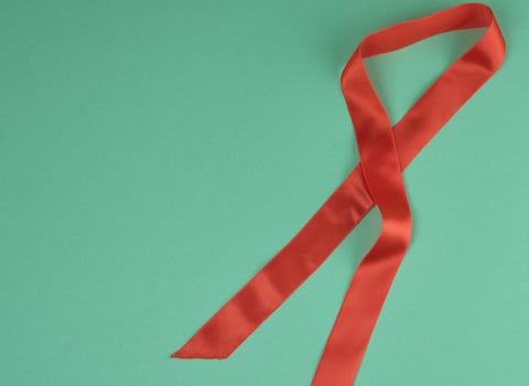 red silk ribbon, green background, top view photo