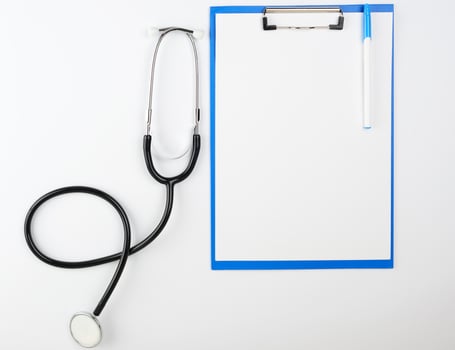 empty white sheets and  medical stethoscope on a white background photo