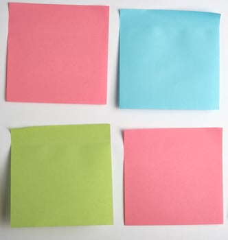 pink, blue, green paper stickers pasted on white  background photo