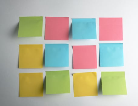 pink, blue, green paper stickers pasted on white  background photo