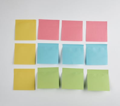 pink, blue, green  paper stickers pasted on white  background photo