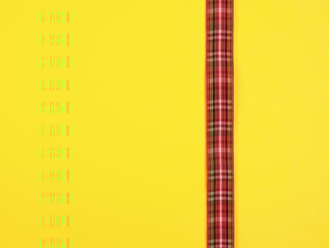 red ribbon in the box on a yellow background photo