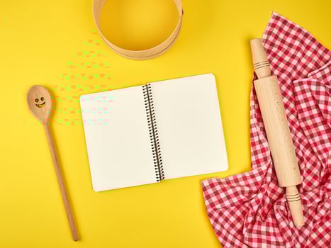 blank open notebook and wooden kitchen accessories photo