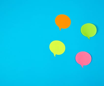 color paper stickers on a blue background, close up photo
