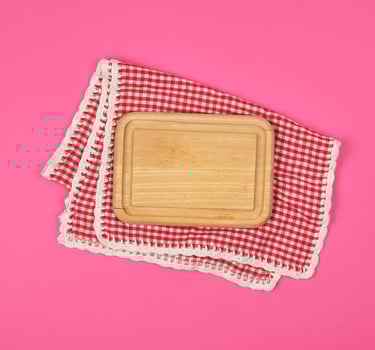 kitchen wooden cutting board and white red checkered kitchen towel photo