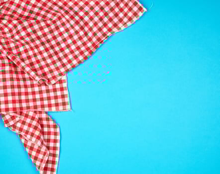 white red checkered kitchen towel on a blue background photo