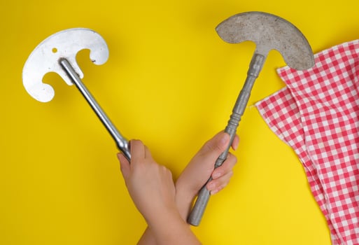 two hands holding vintage sharp kitchen knives for meat and vegetables photo