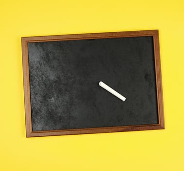 black chalk frame and  piece of white chalk photo