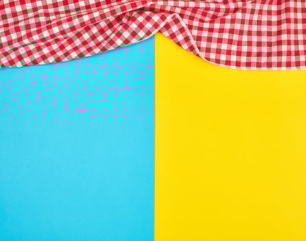 white red checkered kitchen towel on a blue yellow background photo