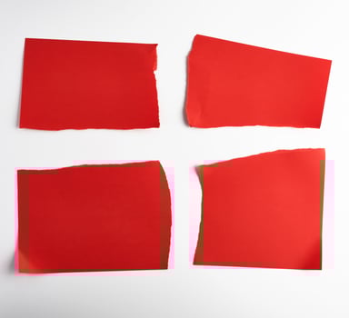 various blank pieces of red paper on white background photo