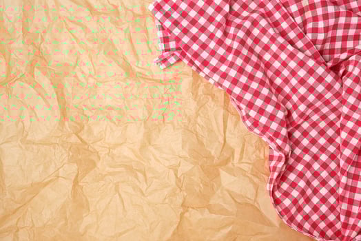 white red checkered kitchen towel on a brown paper background photo