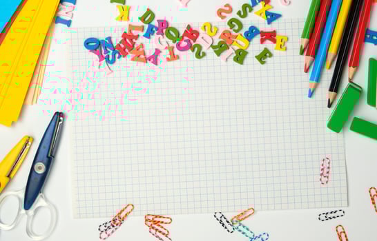 school supplies multicolored wooden pencils,  notebook photo