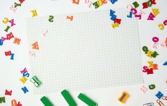 sheets in a cage and small multi-colored wooden letters photo