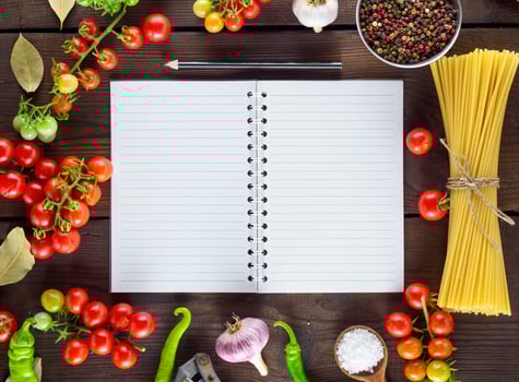 notebook in a line  and ingredients for cooking Italian pasta photo