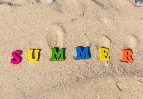 inscription summer from multi-colored wooden letters photo