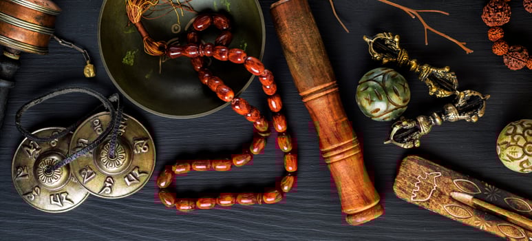 Copper singing bowl, prayer beads, prayer drum photo