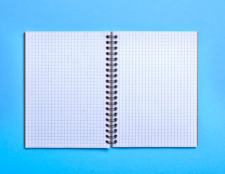 open blank notebook in a box on a blue background photo