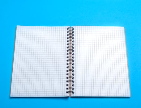 open blank notebook in a box on a blue background photo