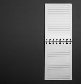 Blank open notebook in a line on a black background photo