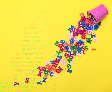 scattered wooden multicolored letters of the English alphabet photo