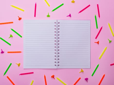 open blank notebook in a line in the middle of a candle photo