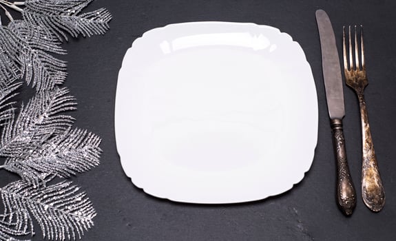 white square plate and vintage metal fork and knife photo