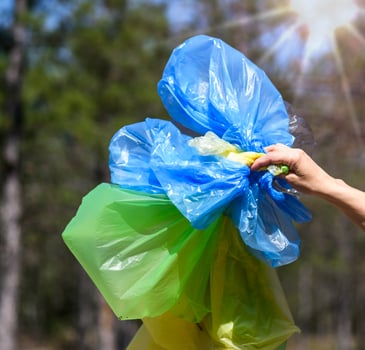 hand shows empty multi-colored polyethylene bags for garbage photo